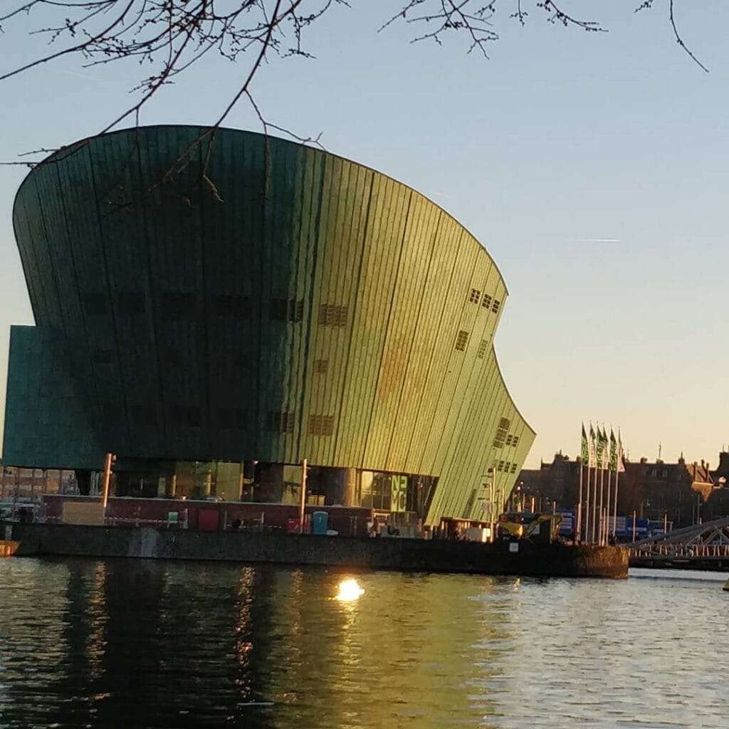Nemo Science Museum in Oosterdok Amsterdam. A copper clad curved bulding on an island in the water