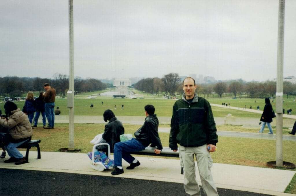 A picture of me standing at the world war 2 memorial in Washington DC with the Lincoln Memorial in the background.
